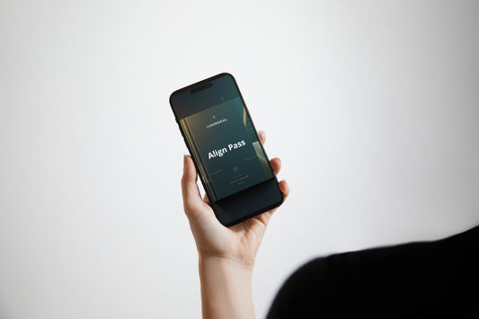 Hand holding a smartphone with 'Align Pass' Swift PDF course on a white background