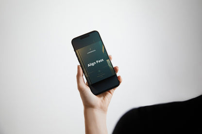 Hand holding a smartphone with 'Align Pass' Swift PDF course on a white background