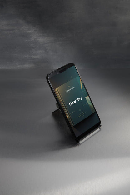 Smartphone on a stand displaying 'Flow Key' Swift course with a dark background