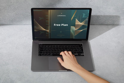 Person using a laptop with a 'Free Plan' Swift course screen on a gray surface