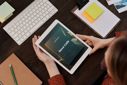 Person using a tablet with 'Nova Code' Swift course on a desk with a keyboard and stationery items.